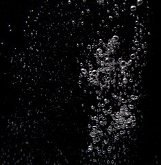 Bubbles rising in water create a mesmerizing underwater effect during a quiet moment
