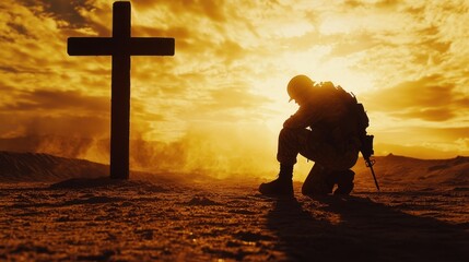 A lone soldier kneeling in front of a wooden cross as the sky glows with warm, dramatic sunset hues.