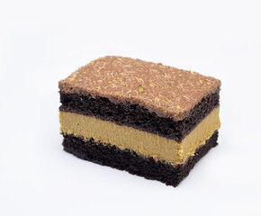 Dubai chocolate cake with layered pistachio filling on white background