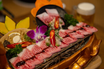 Japanese style sliced beef prepared on the plate, with flower decoration