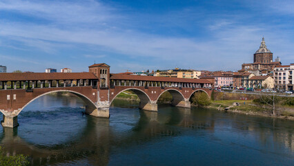 Obraz premium Aerial view of Pavia and the Ticino River. View of the Cathedral of Pavia, Covered Bridge and the Visconti Castle. Lombardia, Italy 