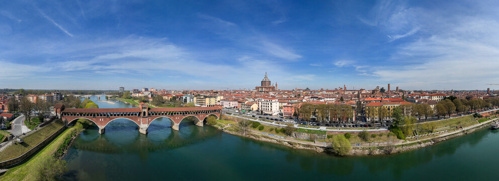 Aerial view of Pavia and the Ticino River. View of the Cathedral of Pavia, Covered Bridge and the Visconti Castle. Lombardia, Italy
