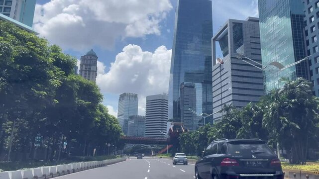 Urban Street Scene With Modern Skyscrapers and Cloudy Sky Dashcam View Cityscape Jakarta Indonesia