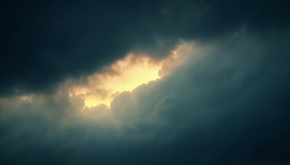 dramatic cloud formation with sunlight breaking through dark clouds