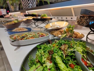 Delicious diverse salads in bowls at a self service buffet restaurant in a luxury hotel