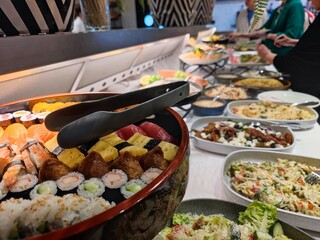 Delicious diverse sushi in bowls at a self service buffet restaurant in a luxury hotel