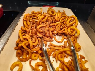 Delicious twister fries at a self service buffet restaurant in a luxury hotel