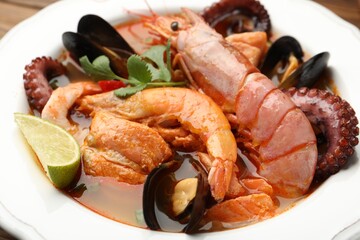 Delicious seafood soup in bowl on table, closeup