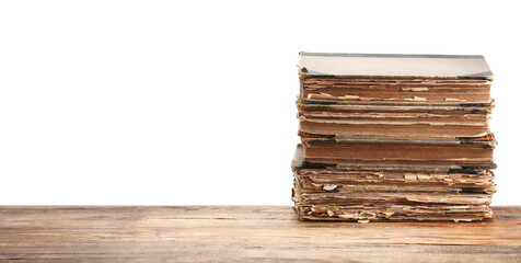 Old books on wooden table against white background