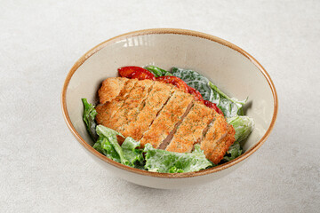 Portion of chicken schnitzel with fresh vegetables
