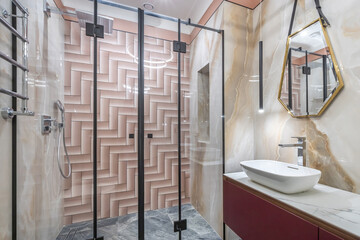 Modern bathroom design, decorated in pastel colors. Shower with glass partition, stylish .accessories.