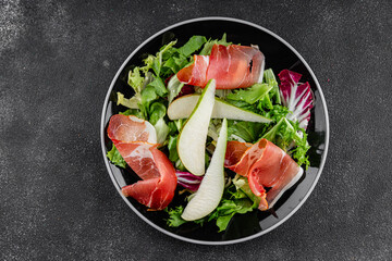 Salad pear ham vegetable dish fresh tasty gourmet food background on the table rustic food top view copy space