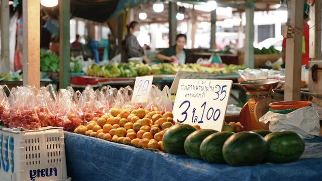 Thailand local market counter with cheap watermelons and fruits on the street market. 