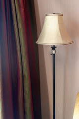 Floor lamp standing on a hotel room