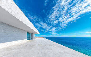 Fototapeta premium Modern architectural design overlooks tranquil ocean waters under a clear blue sky
