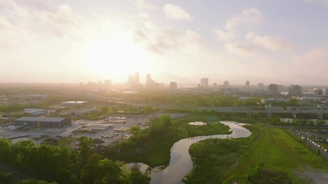 The Downtown Jacksonville Florida skyline at sunrise with the interstate bustling with rush hour traffic as seen from a drone.
