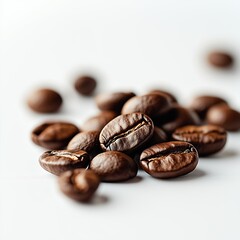 Fototapeta premium Handful of coffee beans on a white table, white background.