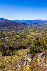 Panorama of Pic des Trois Seigneurs on the horizon and the Douctouyre Valley from the Ariège village of Roquefixade in spring