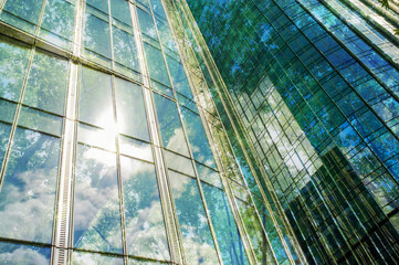 Double exposure of modern buildings and lush trees, low angle view