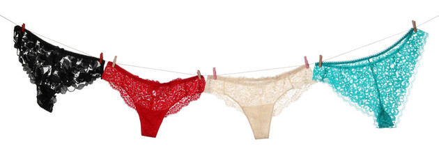 Beautiful panties on clothes line against white background