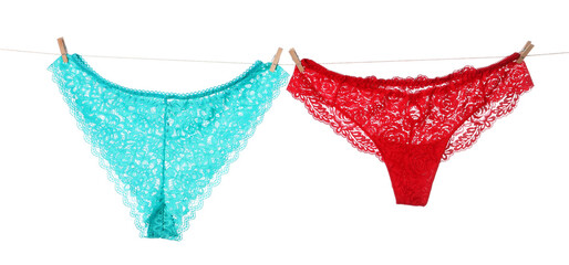 Beautiful panties on clothes line against white background