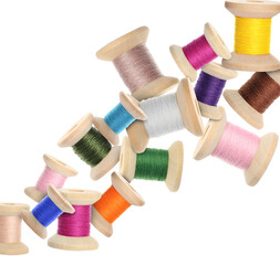 Spools of colorful sewing threads flying on white background