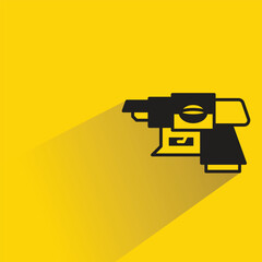 futuristic and space gun icon with shadow on yellow background