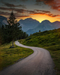 Lonely road in Switzerland mountains, during sunset