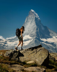 Young , beautiful caucasian woman in Switzerland mountains with matterhorn mountain in background.