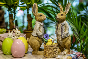 Easter Bunny Figurines with Colorful Eggs and Plants
