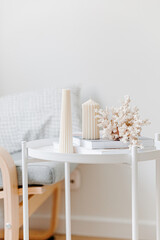 Spa concept. Relax time. Coral, book and candle. White table. Relaxation. Reading. Yoga time. Christmas burning candles on a table.