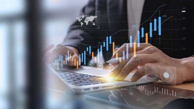 Businessman analyzing financial technology data for investment integration using laptop in modern office, visualizing digital charts, market trends, and fintech insights for economic strategy.