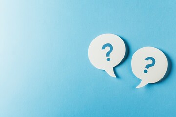 Two white speech bubbles with question marks on a light blue background