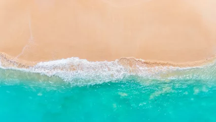 Fotobehang aerial capture of a tropical beach paradise with clear blue ocean waves. summer background and summer holiday concept. © Balnyes Visuals