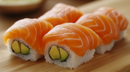 Five salmon avocado sushi rolls on wood