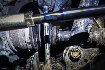 Broken CV joint on the car. The casing burst, lubricant flows. Close up of Damaged broken CV axle...