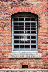 Gridded Window in Red Brick Wall with Arch, Maizuru, Kyoto, Japan