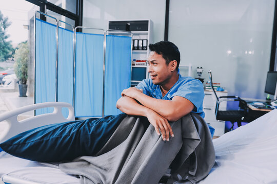 Lonely man silhouette sitting on the bed feeling depressed and stressed in the dark bedroom, Depression and anxiety disorder concept - Powered by Adobe