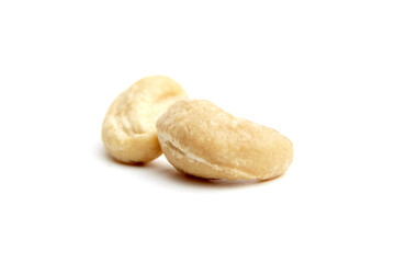 Close-up of two raw cashew nuts with smooth texture and natural cream color, arranged on a white background. Perfect for healthy food concepts