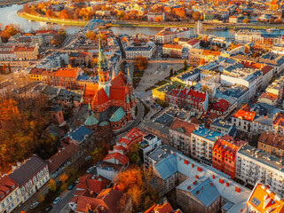 Obraz premium Church Saint Joseph at Podgorski Square in Podgorze district city view near river in Krakow Poland. Autumn landscape on coast river Wisla.