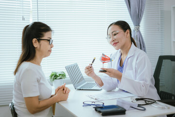 Fototapeta premium Surgeon with human eye model and explains modern clinical treatment