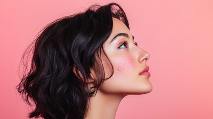 Naklejka premium Profile Portrait of a Young Woman with Dark Hair and Black Veil Against Pink Background