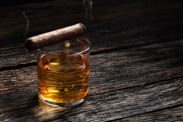 Bourbon in a glass on old wood table