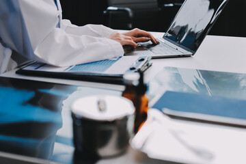 Medical health clinic beautiful Asian doctor working using smart tablet touching, stethoscope diagnosing patient analysis research examination healthcare provider service insurance in modern office