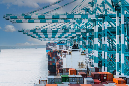 Tanjung Pelepas container terminal - view on the containers and gantry cranes during cargo operations in that big international transport hub. 