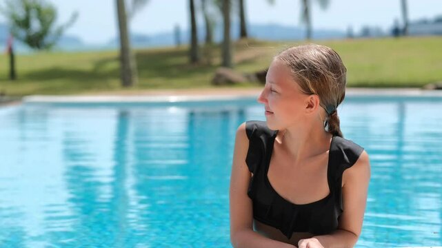 12 year old blond girl enjoying the sun in the pool, children's holidays