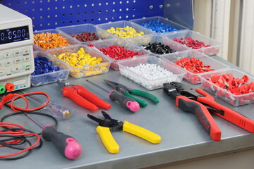 Electrical installation tools for assembling an electrical switchboard on a metal surface. 
