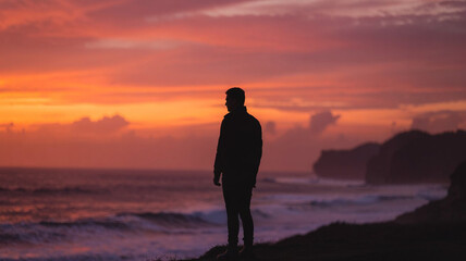Man Watching the Sunset Over the Ocean