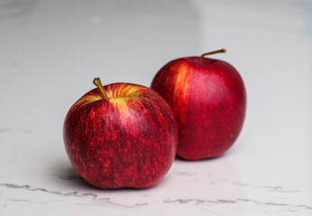 Close-Up of Two Apples on a Smooth Surface