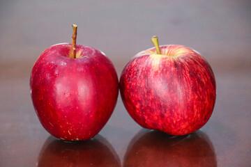 Two Apples Standing Together on Wooden Background